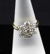 An 18ct gold seven stone diamond cluster ring, size N. Starting Price: £560