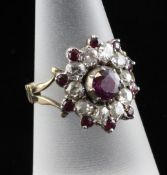 A Victorian gold, ruby and diamond oval cluster ring, with collet set stones and pierced