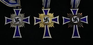 Three classes of the Cross of Honour of the German Mother; bronze, silver and gold. Starting