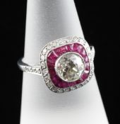 A 1920`s style white gold, ruby and diamond set dress ring, the central stone weighing approximately