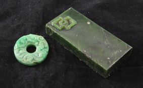 A Chinese jadeite bi disc, carved in relief with chi-dragons, approx. 1.9in., together with a