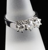 A late 1970`s 18ct white gold and three stone diamond ring, total diamond weight approximately 0.