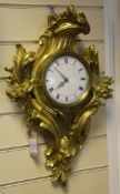 An ormolu cartel clock, in asymmetrical case, with later enamelled dial and quartz movement, 20in.