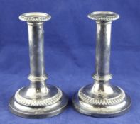 A pair of George III silver dwarf candlesticks, the plain column stems with stepped collar base,