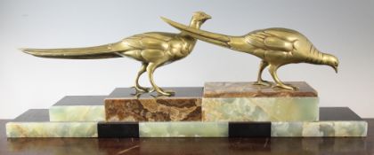 A French Art Deco bronze figure group modelled as a pair of pheasants, on a stepped black marble and