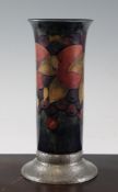 A Moorcroft `Pomegranate` cylindrical vase, on pewter mounted foot, c.1925, on mottled blue green