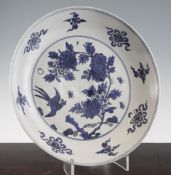 A Chinese blue and white dish, 17th century, painted with a pheasant amid peonies, the border with