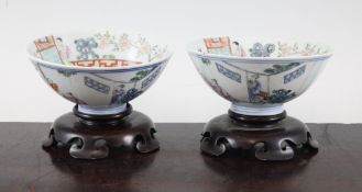 A pair of Chinese famille rose bowls, Qianlong mark, Republic period, each painted with figures amid