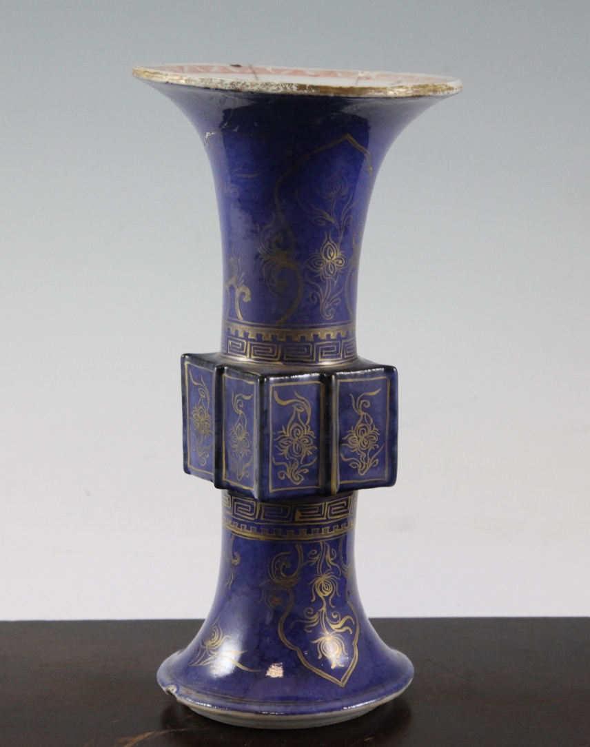 A Chinese gilt-decorated powder blue beaker vase, Gu, Kangxi period, decorated with flowers and