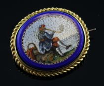 A gold mounted micro mosaic brooch, of oval form, decorated with scene of a seated man smoking a