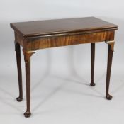 A mid 18th century mahogany folding card table, with concertina action, lappet carved knees, pole