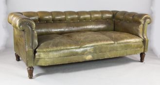 An early 20th century French green leather and button back three seat settee on turned oak legs, W.