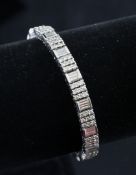 An 18ct white gold and diamond line bracelet, set with rows of round and baguette cut stones, 6.