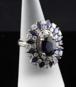 A platinum sapphire and diamond set oval cluster dress ring, size M. Starting Price: £320