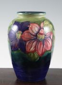 A Moorcroft `Clematis` ovoid vase, c.1935, on graduated blue green ground, inscribed `W.M` and `W