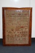 A William IV needlework sampler, named and dated July 1836, within a cushion shaped maple frame,