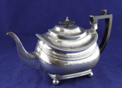 A George III silver teapot, of shaped oval form, with gadrooned border and engraved foliate bands,