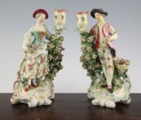 A pair of large Derby candlestick figures, c.1775, modelled as a lady and gentleman holding