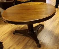 A 19th century circular mahogany breakfast table, the central column and platform base, carved
