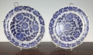 A pair of Chinese blue and white plates, late 19th / early 20th century, each painted with lotus