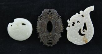 Two Chinese jade carvings and a wood carving, the first celadon and russet jade in the form of an