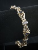 A 9ct gold, diamond and sapphire bracelet, with waisted links set with marquise cut sapphires and