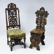 A 19th century Italian carved walnut hall chair, with figural carved back and dished seat,