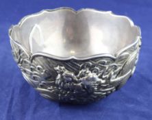 A late 19th/early 20th century Chinese silver bowl, with continuous dragon decoration, lacks foot