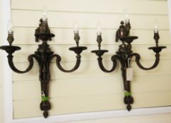 A pair of French transitional style three branch wall lights, with scrolling arms and swags, 22in.