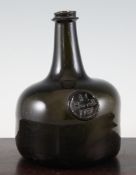 A George II sealed olive green glass mallet shaped wine bottle, I. Howell 1731, with sand disc