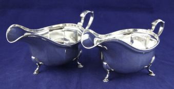 A pair of 1930`s silver sauceboats, with panelled bodies, on pad feet, C.W. Fletcher & Son Ltd,