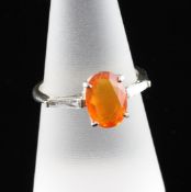 An 18ct gold, fire opal and diamond ring, the opal weighing approximately 1.40ct, with diamond set