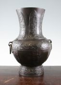 A Chinese archaistic bronze baluster twin handled vase, Yuan / Ming Dynasty, cast in relief with