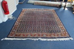 A Tabriz carpet, with tightly packed field of geometric foliate motifs on a deep blue ground, with