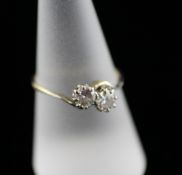 An 18ct gold and two stone diamond crossover ring, size P. Starting Price: £160