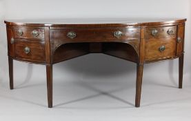 A large George III mahogany demi-lune sideboard, with an arrangement of drawers and cupboard