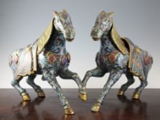 A pair of large Chinese cloisonne enamel figures of prancing horses, each with removable saddles and