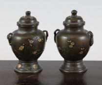 Two Japanese inlaid bronze small baluster vases and covers, late 19th century, each decorated with