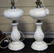 A pair of American milk glass oil lamps with vineous decoration, later converted to electricity,