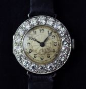 A lady`s 1920`s Swiss platinum and diamond cocktail watch, with Arabic dial and bezel set with