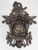 A Camerer Kuss & Co Black Forest cuckoo clock, decorated with a bird, oak leaves and hunting