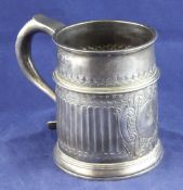 A George II silver mug, of restrained tapering form, with demi fluted body and ornate cartouche with