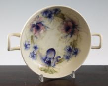 A Moorcroft `Orchid` two handled shallow bowl, c.1930, on matt cream ground, inscribed `W Moorcroft`