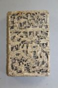 A Chinese export ivory card case, carved in high relief with figures amid pavilions and trees, 4.