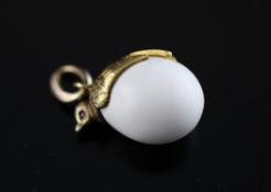 An early 20th century Russian 14ct gold and gem set egg shaped coral pendant, the gold mount