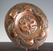 An F.R. Poole of Hayle Arts & Crafts embossed copper fish charger, with maker`s plaque verso, 15.