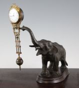 A late 19th century French spelter and gilt brass mystery timepiece, with elephant base, 11in.