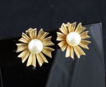 A pair of gold and cultured pearl set ear clips, of flowerhead design, apparently unmarked, 0.