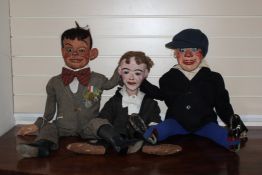 Three ventriloquist dummies, each with papier mache heads and glass eyes, articulated mouths, one