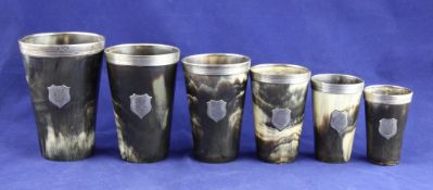 A graduated set of six Victorian silver mounted horn beakers, of tapering form, each inset with